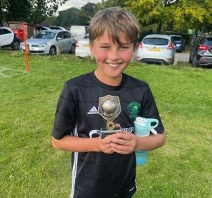 Seb holding a footbal trophy