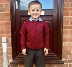 Thomas in school uniform at the front door.