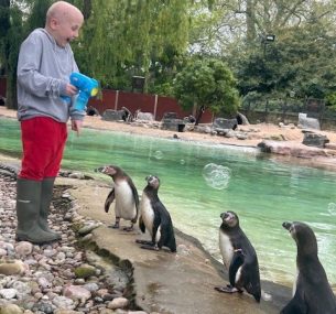 Jamie feeding some penguins