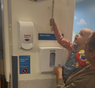 Nancy ringing the end of treatment bell.